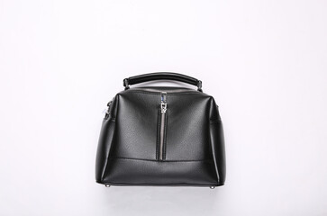 Fashionable leather black handbag on white background. Top view