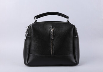 Stylish black leather handbag on gray background