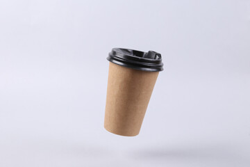 Levitating craft coffee cup on gray background