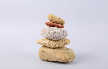 Fototapeta na wymiar Stack with natural sea stones on a gray background