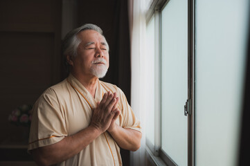 senior citizen stay at hospital, his face look worried about health problem issue, he praying to god wish he has healthy after medical treatment. hospital concept, health care