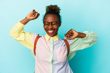 Young student african american woman over isolated background celebrating a special day, jumps and...
