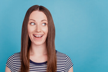 Fototapeta premium Portrait of shocked surprised adorable lady look empty space funny smile on blue background