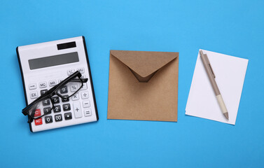 Envelope with letter, calculator on a blue background. Tax payment concept