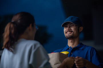 close up portrait of deliverman, smiling guy in blue t-shirt uniform, online shopping grocery products, new normal lifestyle concept, retail shop e-commerce, urban life, delivery transportation.