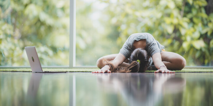 young beautiful caucasian girl doing yoga in the morning, stretching her body after wake up, daily morning routine, healthy lifestyle at home concept. feeling fresh and relaxing