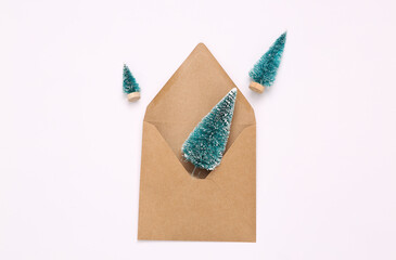 Envelope with decorative mini Christmas trees on a white background.