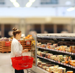 Woman choosing a dairy products at supermarket