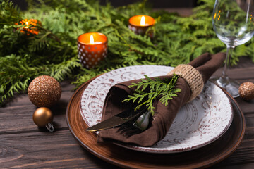 Fototapeta na wymiar Festive table setting with winter decor. Christmas or New Year holiday background.