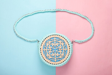 Hand made fashionable handbag on a blue pink pastel background. Top view. Flat lay