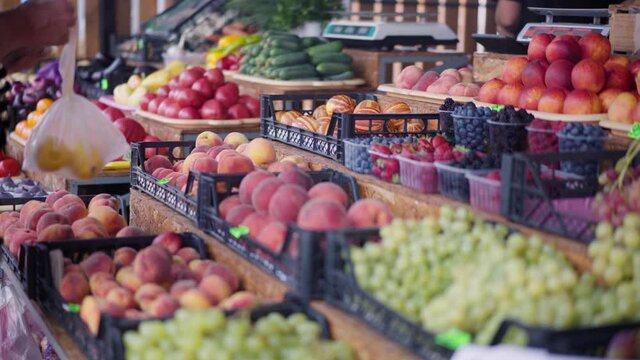 People bay fruit on outdoor market Give many to vendor and keep plastic bag with lemon fruit . High quality 4k footage