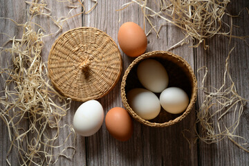 pile of eggs in basket on wooden table - horizontal - closeup