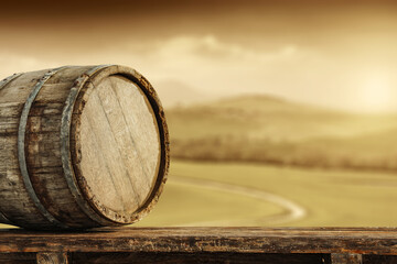 Brown wooden barrel on desk and Tuscany ladnscape 