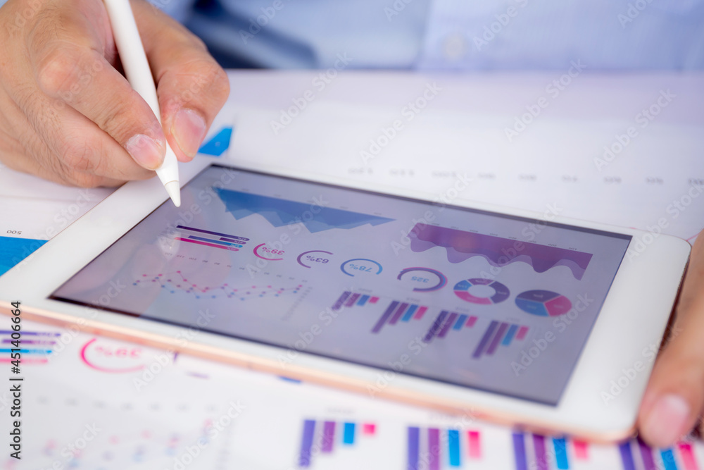 Poster businessman planning about graph and chart of investment with report for finance on tablet computer 