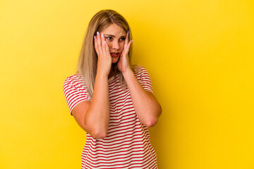 Young russian woman isolated on yellow background whining and crying disconsolately.