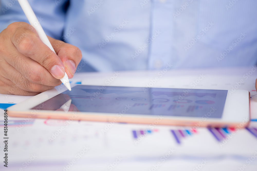 Poster businessman planning about graph and chart of investment with report for finance on tablet computer 