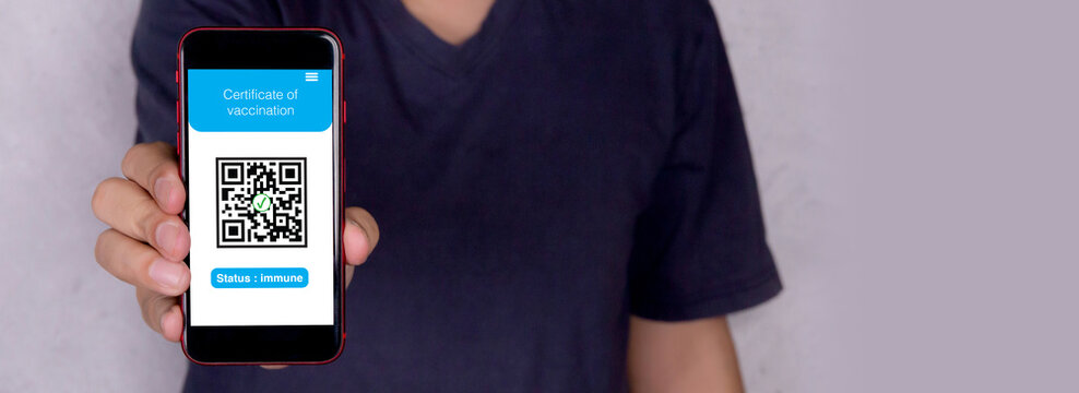 Certificate of vaccination Covid-19, man holding smartphone showing vaccinated, prevention epidemic, health and antibody, one person, male in face mask hold mobile smart phone show identity.