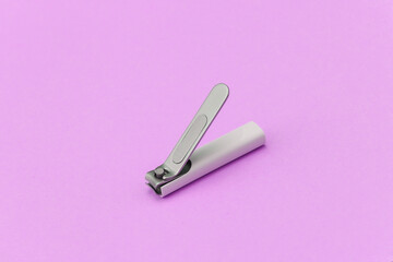 Nail clippers on a pink background close-up