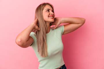 Young russian woman isolated on pink background feeling confident, with hands behind the head.