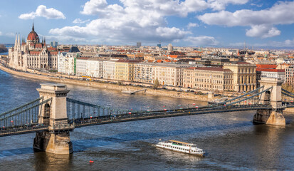 Obraz premium Panorama of Budapest with chain bridge, building of parliament and tourist boat on Danube river in Hungary