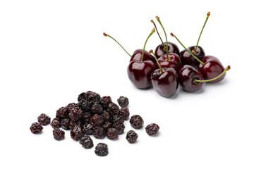 Heap of fresh red ripe juicy cherries and a heap of preserved ones isolated close up on white...