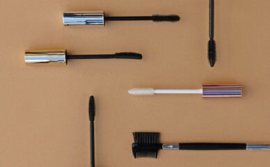 Flat lay makeup set for expressive eyelashes. Different shapes of mascara brushes, eyelash primer, eyebrow and eyelash brush. The concept of accessories, tools and cosmetics for the eyelashes.