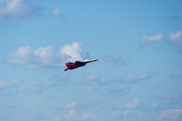 Air show in the sky over the city. Aerobatic group of swifts. Military plane Strizh Mig-29 in the sky