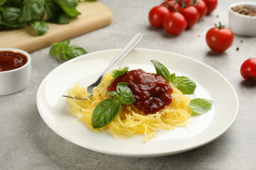 Tasty spaghetti squash with tomato sauce and basil