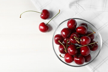 Naklejka na ściany i meble Sweet red cherries on white wooden table, flat lay. Space for text