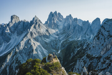 Aerial view of a woman hiker on mountain top enjoying Cadini di Misurina mountain peaks, Italian...