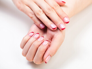 Female hands with a trendy autumn french manicure