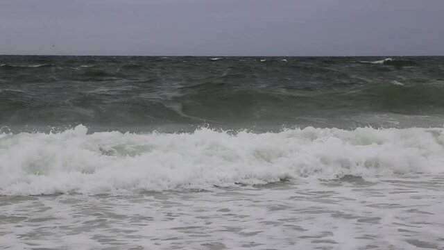Close up of waves getting stronger as a storm is moving in off the coast of Fire Island Long Island New York.