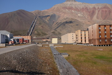 abandoned city with mining equipment in the background