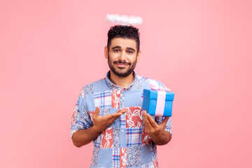 Charity and donations. Portrait of angelic bearded man with halo over head wearing blue shirt...