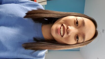 Vertical video of asian young woman has chat with friends with smart phone. Video calling in online chat using smartphone at home. - Powered by Adobe