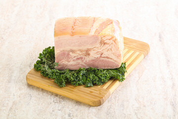 Cut of pork bacon over board