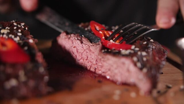 juicy piece of beef ready-made steak on a fork