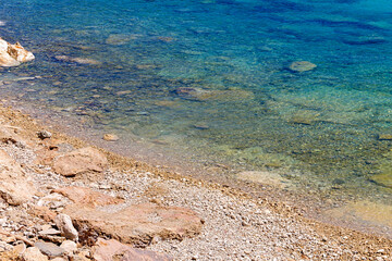 Azure clear water of the Mediterranean Sea. The rocky coast of the resort village of Protaras on the island of Cyprus. No people.