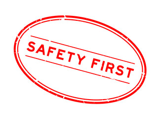 Grunge red safety first word oval rubber seal stamp on white background