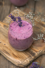 Obraz na płótnie Canvas Lavender smoothie with coconut milk, blueberry. Vegan beverage