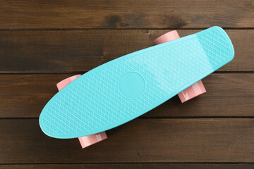 Turquoise skateboard on wooden background, top view. Sport equipment © New Africa