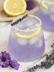 Iced fresh lavender-lemonade soda drink top with its flower branch, lemon and purple...