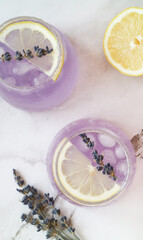 Top view of fresh sparkling lavender-lemonade soda drink in glass salt&sugar at edge of...