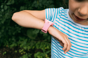 Smart watch on the child's hand. Girl kid includes smart watches finger.