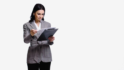Businesswoman looking at papers on clipboard isolated on white.