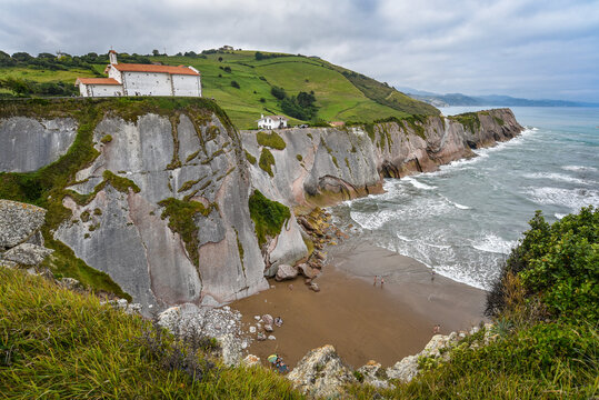 Zumaia, Spain - 14 August 2021: San Telmo Church and the Flysch cliffs at the coast of Zumaia.