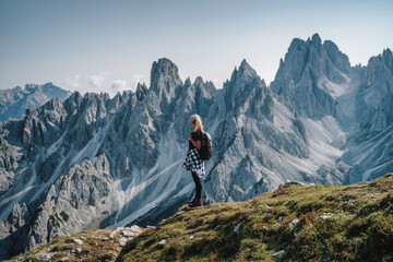 Woman hiker with backpack enjoying Cadini di Misurina mountain group range of Italian Alps, Dolomites, Italy, Europe