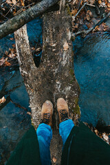 Selfie of feet in boots in autumn or spring forest. Travel and Adventure