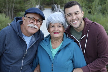 Ethnic grandparents with adult son in the park