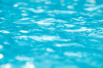 Water and air bubbles over blue background,sea wave ,Bokeh light background in the pool,Hotel swimming pool with sunny reflections.